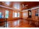 Bright living room with hardwood floors, wood paneling, and built-in shelves at 258 Big Oak Rd, Whitesburg, GA 30185