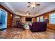 Spacious living room boasts wood paneling, hardwood floors, fireplace, and two ceiling fans at 258 Big Oak Rd, Whitesburg, GA 30185