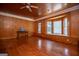 Spacious living room features hardwood floors, wood paneling, and a bay window with bench at 258 Big Oak Rd, Whitesburg, GA 30185