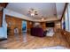 Open concept living room with a brick fireplace, hardwood floors, and access to the bedroom at 258 Big Oak Rd, Whitesburg, GA 30185