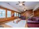 Bright living room with hardwood floors, cozy seating, and views of the front yard through large windows at 258 Big Oak Rd, Whitesburg, GA 30185