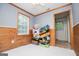 Living room features wood paneling and trim, with ample natural light and space at 258 Big Oak Rd, Whitesburg, GA 30185