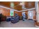 Large, comfortable living room with wood paneled walls, carpet, lots of light and seating at 258 Big Oak Rd, Whitesburg, GA 30185