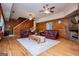 Spacious living room with a brick fireplace, hardwood floors, and access to other rooms at 258 Big Oak Rd, Whitesburg, GA 30185