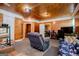 Cozy living room featuring wood paneled walls, carpet and a comfortable recliner and sofa at 258 Big Oak Rd, Whitesburg, GA 30185