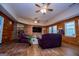 Spacious living room boasts wood paneling, hardwood floors, fireplace, and two ceiling fans at 258 Big Oak Rd, Whitesburg, GA 30185