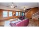 Spacious living room featuring wood-paneled walls, hardwood floors, and comfortable seating area at 258 Big Oak Rd, Whitesburg, GA 30185