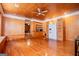 Spacious living room featuring hardwood floors and a white refrigerator hidden behind sliding doors at 258 Big Oak Rd, Whitesburg, GA 30185