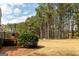 Expansive backyard with a deck and beautiful, mature trees providing shade and privacy at 165 Longshore Way, Fayetteville, GA 30215