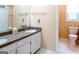 Bathroom featuring double sinks, granite countertops, and a separate toilet area at 165 Longshore Way, Fayetteville, GA 30215