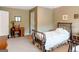 Bedroom featuring a bed with a floral quilt, a wooden desk, and neutral walls at 165 Longshore Way, Fayetteville, GA 30215