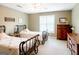 Bedroom showcasing twin beds with wrought iron frames and matching wooden dressers at 165 Longshore Way, Fayetteville, GA 30215