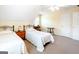Bright bedroom with twin beds, neutral walls, and a view of the yard from the window at 165 Longshore Way, Fayetteville, GA 30215