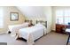 Comfortable bedroom featuring twin beds, neutral walls, and natural light from a window at 165 Longshore Way, Fayetteville, GA 30215