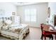 Bedroom with a floral quilt, vintage furniture, neutral walls, and natural light at 165 Longshore Way, Fayetteville, GA 30215