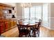 Spacious dining room featuring a large window with shutters and ample seating for eight at 165 Longshore Way, Fayetteville, GA 30215