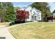 Landscaped front yard showcasing the home's curb appeal and mature trees at 165 Longshore Way, Fayetteville, GA 30215