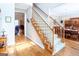 Elegant foyer showcasing the staircase and a glimpse into the living and dining areas at 165 Longshore Way, Fayetteville, GA 30215
