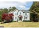 Beautiful two-story home with manicured lawn and a charming American flag display at 165 Longshore Way, Fayetteville, GA 30215