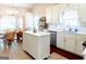 Bright kitchen featuring an island, quartz countertops, stainless steel appliances and tile flooring at 165 Longshore Way, Fayetteville, GA 30215