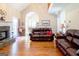 Spacious living room features a stone fireplace, hardwood floors, and an open floor plan at 165 Longshore Way, Fayetteville, GA 30215