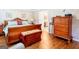 Warm and inviting bedroom with a large sleigh bed, warm paint, and hardwood floors at 165 Longshore Way, Fayetteville, GA 30215