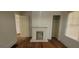 Cozy bedroom with a charming decorative fireplace and hardwood flooring at 2916 Memorial Se Dr, Atlanta, GA 30317