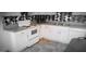 Kitchen with white cabinetry, black and white back splash, and tile flooring at 2916 Memorial Se Dr, Atlanta, GA 30317