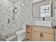 Modern bathroom features marble wall tiles, a glass shower, and a wood vanity with a vessel sink at 1240 Hayes Sq, Peachtree City, GA 30269