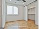Bedroom with natural light, hardwood floors, and access to the closet at 1240 Hayes Sq, Peachtree City, GA 30269