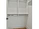 Spacious walk-in closet with custom shelving and rods for organized storage at 1240 Hayes Sq, Peachtree City, GA 30269