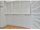 Well-organized walk-in closet with built-in shelving and rods for efficient storage solutions at 1240 Hayes Sq, Peachtree City, GA 30269