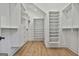 Walk-in closet with custom shelving and storage solutions and hardwood flooring at 1240 Hayes Sq, Peachtree City, GA 30269
