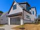 Two-story home with white siding, black trim, and an attached garage at 1240 Hayes Sq, Peachtree City, GA 30269