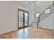 Bright foyer featuring hardwood floors, staircase, and natural light from a front door at 1240 Hayes Sq, Peachtree City, GA 30269