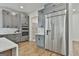 Modern kitchen featuring gray cabinetry, stainless steel appliances, and a large refrigerator at 1240 Hayes Sq, Peachtree City, GA 30269