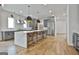 Spacious open kitchen with large island, stainless steel appliances, and seating for three at 1240 Hayes Sq, Peachtree City, GA 30269