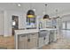This spacious kitchen island features stainless steel sink, dishwasher, and white marble countertop at 1240 Hayes Sq, Peachtree City, GA 30269