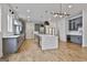 Modern kitchen with stainless steel appliances, gray cabinets, and a large island with quartz countertops at 1240 Hayes Sq, Peachtree City, GA 30269