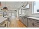 Modern kitchen features stainless steel appliances, gray cabinets, and a large island with quartz countertops at 1240 Hayes Sq, Peachtree City, GA 30269