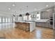 Spacious kitchen with a large island, modern pendant lighting, and stainless steel appliances at 1240 Hayes Sq, Peachtree City, GA 30269