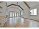 Large living room with vaulted ceilings, wood beams, fireplace, built-ins, and hardwood floors at 1240 Hayes Sq, Peachtree City, GA 30269