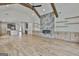 Open floor plan view of the living room and kitchen with hardwood floors and vaulted ceilings at 1240 Hayes Sq, Peachtree City, GA 30269
