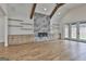 Bright living room featuring fireplace, built-in shelves and cabinets, ceiling fan, and hardwood floors at 1240 Hayes Sq, Peachtree City, GA 30269