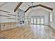 Spacious living room with vaulted ceilings, wood beams, fireplace, built-ins, and hardwood floors at 1240 Hayes Sq, Peachtree City, GA 30269