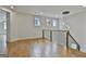 Open loft space with hardwood floors, natural light, and elegant light fixture at 1240 Hayes Sq, Peachtree City, GA 30269