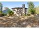 Exterior rear view featuring a spacious backyard with mature trees at 475 Louise Way, Locust Grove, GA 30248