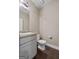 A half bath with a granite sink and light grey painted vanity at 475 Louise Way, Locust Grove, GA 30248