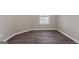 A bright bedroom with a window, neutral walls, and hardwood flooring at 475 Louise Way, Locust Grove, GA 30248