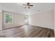 Spacious bedroom with two large windows offering ample natural light and wood-look flooring at 475 Louise Way, Locust Grove, GA 30248